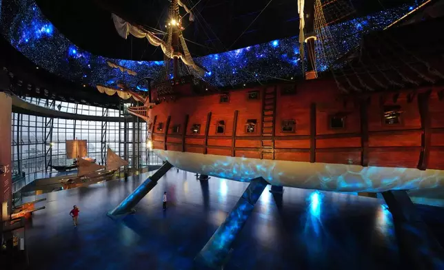 Visitors look at the Espiritu Santo galleon, a full-scale reproduction of a 17th century Spanish galleon as it sits as the centerpiece of Museo del Galeon in Manila, Philippines on Friday, Aug. 28, 2026. (AP Photo/Aaron Favila)