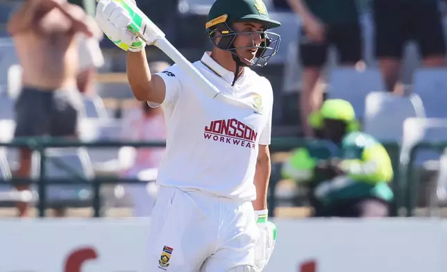 South Africa's Marques Ackerman celebrates his fifty on day three of the third cricket test match between South Africa and Australia, in Cape Town, South Africa, Thursday, Oct. 29, 2026. (AP Photo/Halden Krog)