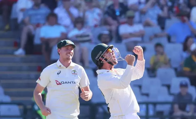 Australia's Travis Head, right, celebrates the wicket of South Africa's Marques Ackerman on day three of the third cricket test match between South Africa and Australia, in Cape Town, South Africa, Thursday, Oct. 29, 2026. (AP Photo/Halden Krog)