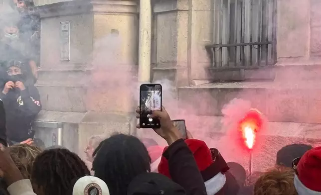 In this photo taken with a smartphone, high school students block the entrance of Voltaire high school to demand more resources, in Paris, Thursday, Oct. 1, 2026. (AP Photo/Nicolas Garriga)