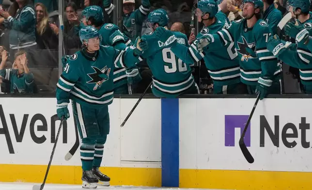 San Jose Sharks left wing Ivar Stenberg (41) is congratulated by teammates after scoring against the Boston Bruins during the second period of an NHL hockey game, Tuesday, Oct. 13, 2026, San Jose, Calif. (AP Photo/Jeff Chiu)