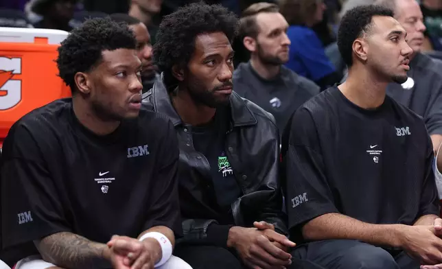 Toronto Raptors forward Kawhi Leonard, middle, looks on during the second half of an NBA basketball game against the Minnesota Timberwolves, Sunday, Oct. 25, 2026, in Minneapolis. (AP Photo/Bailey Hillesheim)