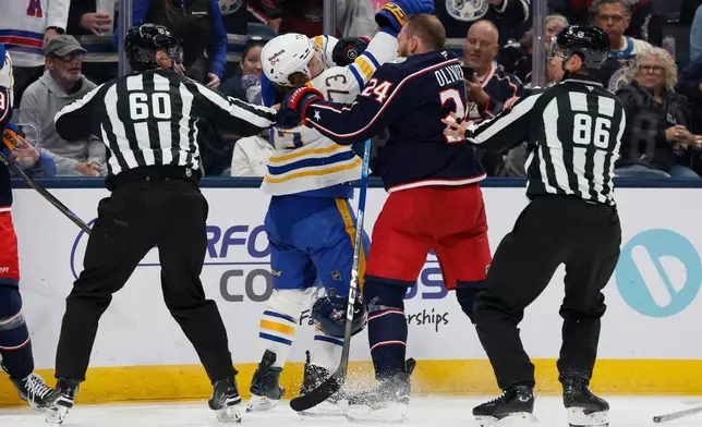Buffalo Sabres' Zach Metsa (73)and Columbus Blue Jackets' Mathieu Olivier (24) fight during the second period of an NHL hockey game, Thursday, Oct. 1, 2026, in Columbus, Ohio. (AP Photo/Jay LaPrete)