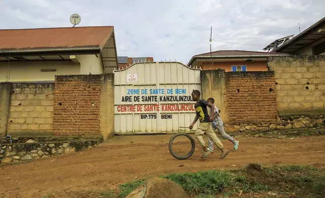 Children play outside a health center amidst an outbreak of the Ebola virus, in Beni, North Kivu province, eastern Congo, Friday, Oct. 16, 2026. (AP Photo/Sebastien Kitsa Musayi)