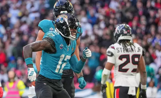 Jacksonville Jaguars wide receiver Travis Hunter (12) celebrates after scoring a touchdown during an NFL football game against Houston Texans in London, Sunday, Oct. 18, 2026. (AP Photo/Kin Cheung)