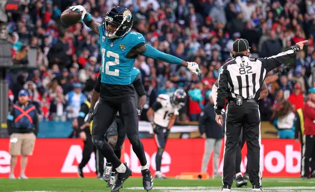 Jacksonville Jaguars wide receiver Travis Hunter (12) celebrates after making an interception during an NFL football game against Houston Texans in London, Sunday, Oct. 18, 2026. (AP Photo/Ian Walton)