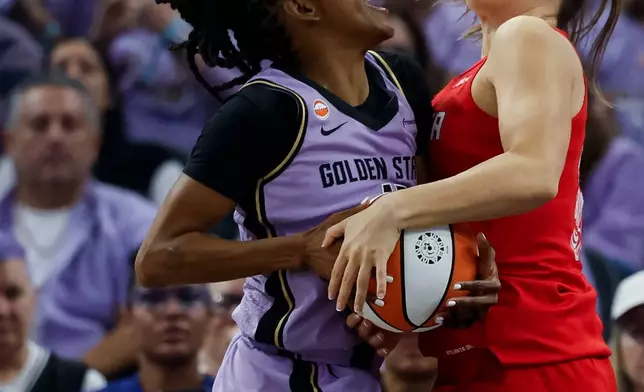 Golden State Valkyries guard Tiffany Hayes, left, and Atlanta Dream guard Isobel Borlase, right, compete for possession of the ball during the first half of Game 2 of the WNBA basketball finals in San Francisco, Monday, Oct. 19, 2026. (Carlos Avila Gonzalez/San Francisco Chronicle via AP)