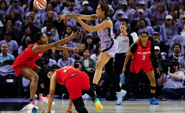 Golden State Valkyries forward Gabby Williams (1) passes the ball while defended by Atlanta Dream forward Angel Reese, left, during the first half of Game 2 of the WNBA basketball finals in San Francisco, Monday, Oct. 19, 2026. (Carlos Avila Gonzalez/San Francisco Chronicle via AP)