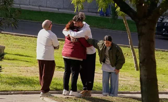 People searching for relatives who were traveling on the trains involved in a collision gather at a religious residence converted into a temporary medical facility in Toledo, Spain, Thursday, Oct. 29, 2026. (AP Photo/Andrea Comas)