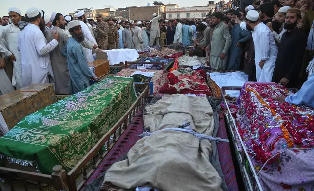 Mourners attend funeral prayers of children, who were died in a roof collapse of a private school, in Peshawar, Pakistan, Thursday, Oct. 15, 2026. (AP Photo/Muhammad Zubair)