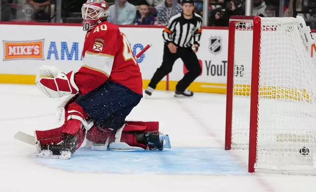The puck gets past Florida Panthers goaltender Akira Schmid (40) on a goal scored by Vancouver Canucks defenseman Elias Pettersson during the first period of an NHL hockey game, Thursday, Oct. 15, 2026, in Sunrise, Fla. (AP Photo/Lynne Sladky)