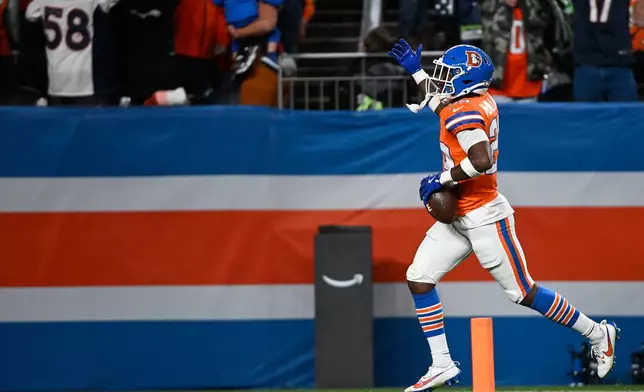 Denver Broncos cornerback Ja'Quan McMillian celebrates an interception against the Seattle Seahawks during overtime in an NFL football game in Denver, Thursday, Oct. 15, 2026. (AP Photo/Geneva Heffernan)