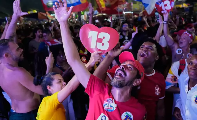 Supporters of President Luiz Inacio Lula da Silva celebrate after he wins a fourth term in the presidential runoff in Rio de Janeiro, Brazil, Sunday, Oct. 25, 2026. (AP Photo/Silvia Izquierdo)
