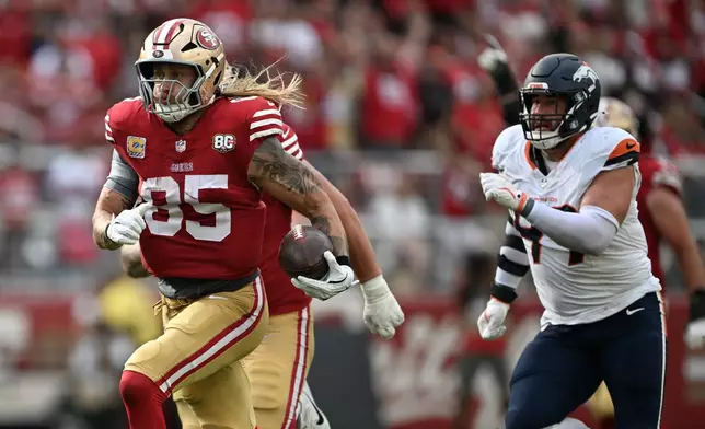 San Francisco 49ers tight end George Kittle (85) runs past Denver Broncos defensive end Zach Allen to score during the second half of an NFL football game in Santa Clara, Calif., Sunday, Oct. 4, 2026. (AP Photo/Justine Willard)