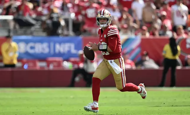 San Francisco 49ers quarterback Brock Purdy (13) rolls out during the first half of an NFL football game against the Denver Broncos in Santa Clara, Calif., Sunday, Oct. 4, 2026. (AP Photo/Justine Willard)