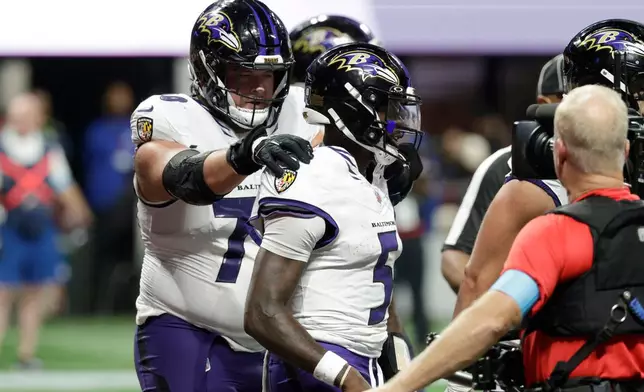 Baltimore Ravens quarterback Tyler Huntley (5) celebrates with teammates after a touchdown run during overtime in a NFL football game against the Atlanta Falcons, Sunday, Oct. 11, 2026, in Atlanta. (AP Photo/Erik S. Lesser)