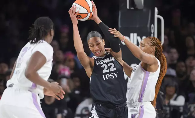 Las Vegas Aces center A'ja Wilson (22) secures a rebound against Golden State Valkyries forward Kayla Thornton, right, during the first half of Game 3 of the WNBA basketball semifinals Friday, Oct. 9, 2026, in Las Vegas. (AP Photo/Ian Maule)