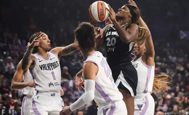 Las Vegas Aces Kalani Brown (20) looks to shoot against Golden State Valkyries forward Gabby Williams (1) during the first half of Game 3 of the WNBA basketball semifinals Friday, Oct. 9, 2026, in Las Vegas. (AP Photo/Ian Maule)