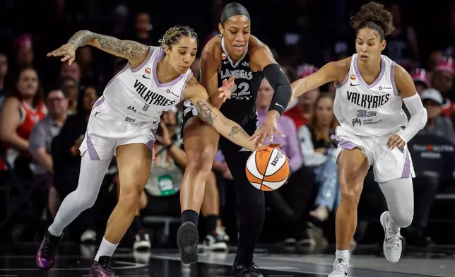 Golden State Valkyries' Gabby Williams (1) and Veronica Burton (22) defend against Las Vegas Aces’ A'ja Wilson (22) during the first half of Game 3 of the WNBA basketball semifinals Friday, Oct. 9, 2026, in Las Vegas.(Carlos Avila Gonzalez/San Francisco Chronicle via AP)/San Francisco Chronicle via AP)