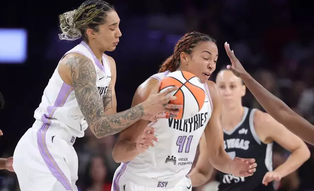 Golden State Valkyries forward Gabby Williams, left, and center Kiah Stokes (41) collide while going for the ball against the Las Vegas Aces during the first half of Game 3 of the WNBA basketball semifinals Friday, Oct. 9, 2026, in Las Vegas. (AP Photo/Ian Maule)