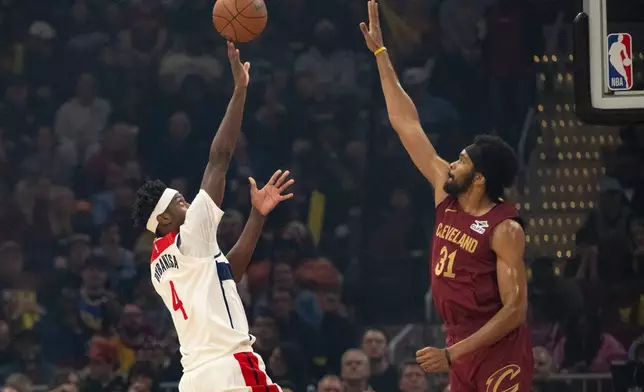 Washington Wizards' AJ Dybantsa (4) shoots over Cleveland Cavaliers' Jarrett Allen (31) during the first half of an NBA basketball game in Cleveland, Wednesday, Oct. 28, 2026. (AP Photo/Phil Long)