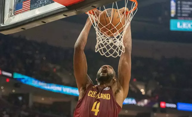 Cleveland Cavaliers' Evan Mobley (4) dunks against the Washington Wizards during the first half of an NBA basketball game in Cleveland, Wednesday, Oct. 28, 2026. (AP Photo/Phil Long)