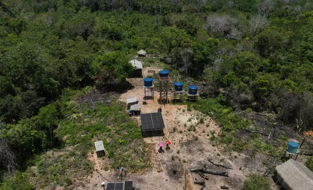 Solar panels operate near water tanks in Nova Sociedade, a riverine Arapium Indigenous community, near Santarem, Para state, Brazil, Thursday, Sept. 3, 2026. (AP Photo/Andre Penner)
