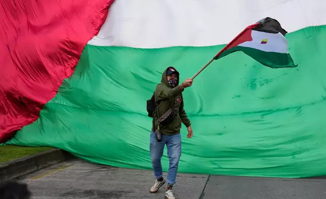 A pro-Palestinian demonstrator protests outside the Israel Embassy to show solidarity with the Palestinian people living in Gaza, Wednesday, Oct. 7, 2026, Bogota, Colombia. (AP Photo/Fernando Vergara)
