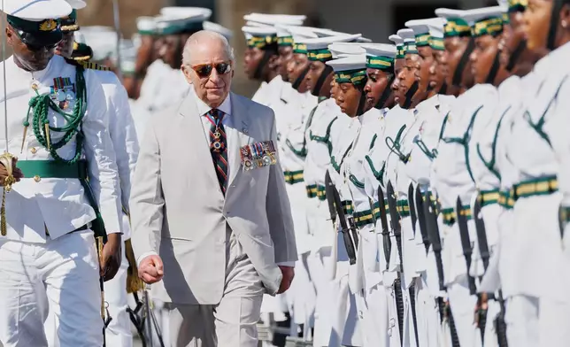 Britain's King Charles III inspects the guard of honor at the Royal Bahamas Defence Force Base in Nassau, Bahamas, Wednesday, Oct. 28, 2026. (AP Photo/Tim Aylen)