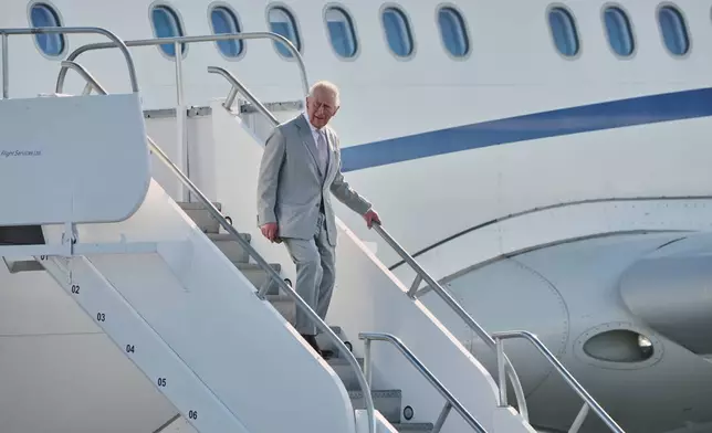 Britain's King Charles III deplanes at Lynden Pindling Airport in Nassau, Bahamas, Tuesday, Oct. 27, 2026. (AP Photo/Tim Aylen)