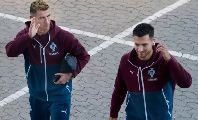 Portugal's Cristiano Ronaldo, left, and Diogo Dalot arrive for training in Copenhagen, Denmark, Wednesday, Sept. 30, 2026, ahead of their Nations League soccer match against Denmark. (Liselotte Sabroe/Ritzau Scanpix via AP)