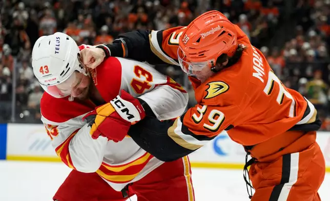 Anaheim Ducks left wing Jeff Malott (39) fights against Calgary Flames right wing Adam Klapka (43) during the second period of an NHL hockey game, Tuesday, Oct. 13, 2026, in Anaheim, Calif. (AP Photo/Kyusung Gong)