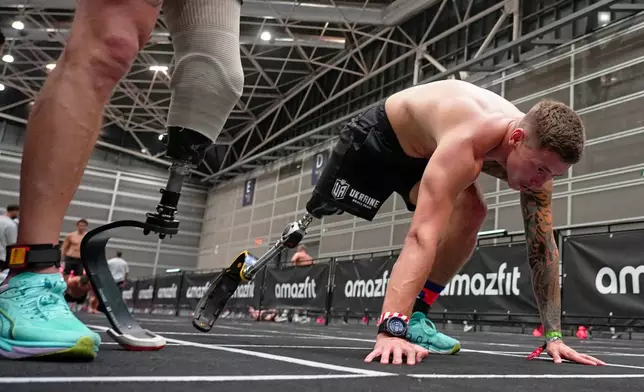 Ukrainian veterans Oleksii Doroshenko, left, and Ivan Artiukh compete in the adaptive division during the HYROX event in Valencia, Spain, Sunday, Oct. 18, 2026. (AP Photo/Alberto Sáiz)