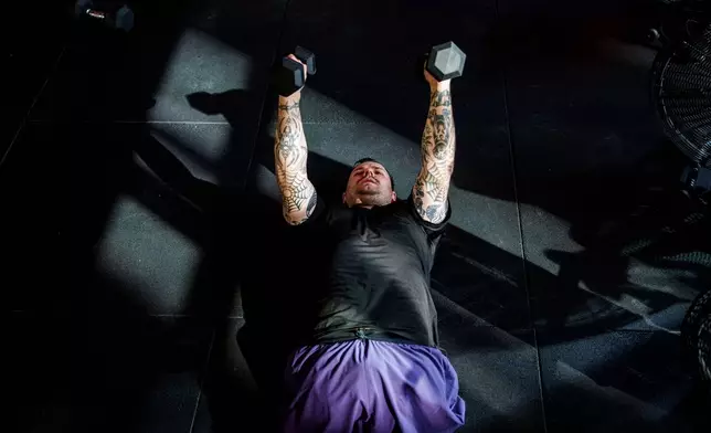 Dmytro Bykhovchenko, a Ukrainian war veteran, trains in a gym for the upcoming HYROX competition in Valencia, in Kyiv, Ukraine, Sunday, Oct. 11, 2026. (AP Photo/Evgeniy Maloletka)