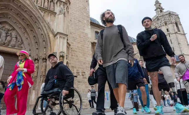 From left, Ukrainian veterans Dmytro Bykhovchenko, Oleh Tserkovnyy and Oleksii Doroshenko walk through Valencia, Spain, Sunday, Oct. 18, 2026. (AP Photo/Alberto Sáiz)