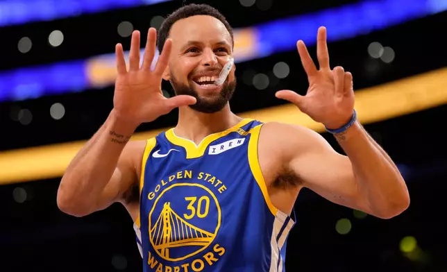 Golden State Warriors guard Stephen Curry gestures toward fans prior to an NBA basketball game against the Los Angeles Lakers, Wednesday, Oct. 21, 2026, in Los Angeles. (AP Photo/Mark J. Terrill)
