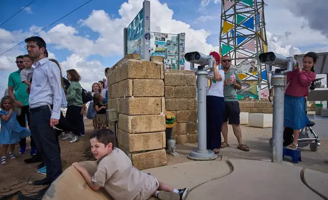Visitors gather on a hill overlooking the Gaza Strip in Sderot, southern Israel, Thursday, Oct. 1, 2026. (AP Photo/Oded Balilty)