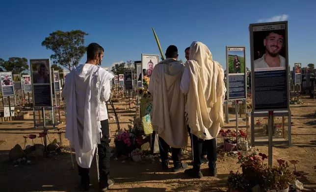 Jews wearing prayer shawls for the holiday of Sukkot visit the site of the Nova music festival, where hundreds of revelers were killed and abducted three years prior in the Oct. 7 Hamas attack, near Kibbutz Reim in southern Israel, Friday, Oct. 2, 2026. (AP Photo/Oded Balilty)
