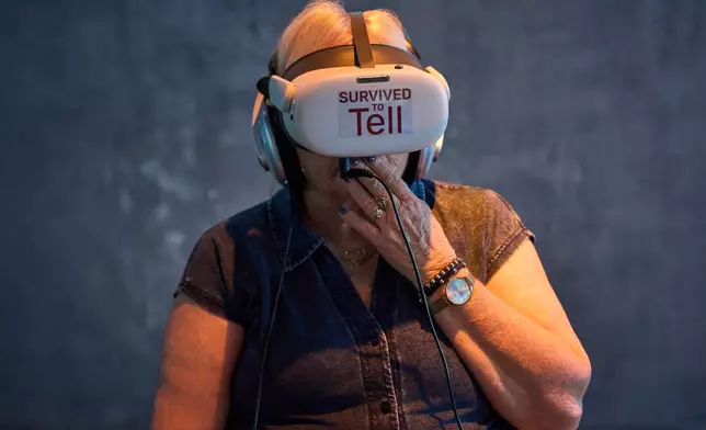 Levana Hadad watches testimonies from the survivors of Hamas' Oct. 7 attack on Israel three years prior as part of a project titled "Real Time Oct. 7," at the Sderot Visitors Center in Sderot, southern Israel, Wednesday, Oct. 1, 2026. (AP Photo/Oded Balilty)