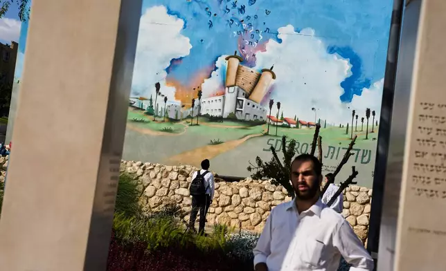 People visit a memorial at a police station attacked by Hamas on Oct. 7 three years prior, in Sderot, southern Israel, Sunday, Oct. 4, 2026. (AP Photo/Oded Balilty)
