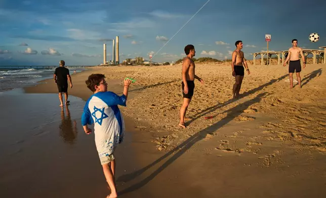 People spend the day on Zikim Beach, one of the sites targeted on Oct. 7 three years prior during the Hamas attack, in southern Israel near the Israel-Gaza border, Thursday, Oct. 1, 2026. (AP Photo/Oded Balilty)