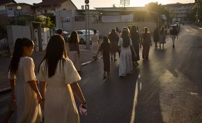 Israelis mark the Simchat Torah Jewish holiday on Saturday, Oct. 3, 2026, in Sderot, one of the areas in southern Israel attacked by Hamas three years prior on Oct. 7. (AP Photo/Oded Balilty)