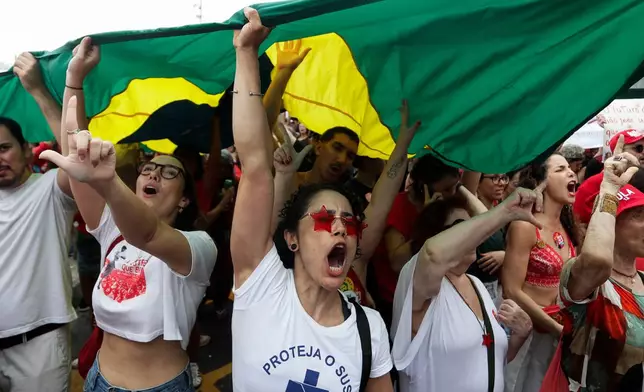 People attend a campaign rally of support for Brazilian President Luiz Inacio Lula da Silva, who is running for a fourth term, ahead of the presidential runoff election at Copacabana Beach in Rio de Janeiro, Monday, Oct. 12, 2026. (AP Photo/Bruna Prado)