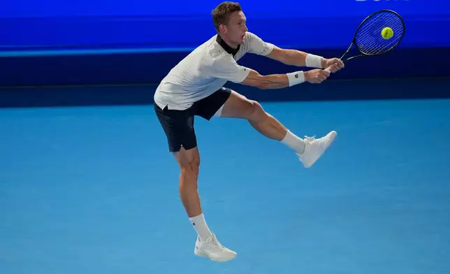 Czechia's Jiri Lehecka returns to Spains Carlos Alcaraz during their men's singles final at the Japan Open tennis tournament in Tokyo, Tuesday, Oct. 6, 2026. (AP Photo/Eugene Hoshiko)