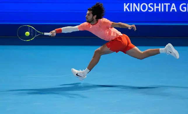 Spain's Carlos Alcaraz returns to Czechia's Jiri Lehecka during their men's singles final at the Japan Open tennis tournament in Tokyo, Tuesday, Oct. 6, 2026. (AP Photo/Eugene Hoshiko)
