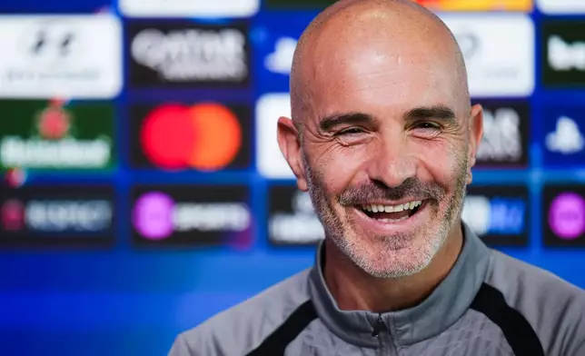 Manchester City manager Enzo Maresca smiles during a press conference Tuesday, Oct. 13, 2026, in Manchester, England, a day ahead of their Champions League soccer match against Paris Saint-Germain. (Martin Rickett/PA via AP)