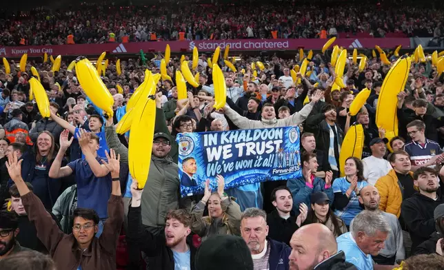 Manchester City fans cheer their team during the English Premier League soccer match between Liverpool and Manchester City in Liverpool, England, Sunday, Oct. 11, 2026. (AP Photo/Jon Super)