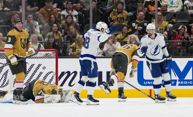 Tampa Bay Lightning center Anthony Cirelli, right, celebrates after scoring against the Vegas Golden Knights during the second period of an NHL hockey game Tuesday, Oct. 20, 2026, in Las Vegas. (AP Photo/John Locher)