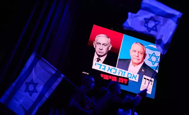 A screen projects an image of Israeli Prime Minister Benjamin Netanyahu, left, and his main rival, opposition candidate Gadi Eisenkot, leader of the Yashar ("Straight") party, during a campaign rally for Eisenkot ahead of Israel's general election, Sunday, Oct. 25, 2026, in Tel Aviv, Israel. (AP Photo/David Goldman)