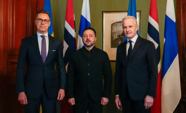 Ukrainian President Volodymyr Zelenskyy, center, poses with Norwegian Prime Minister Jonas Gahr Støre and Finnish President Alexander Stubb, left, in Oslo, Norway, Tuesday, Oct. 20, 2026. (Heiko Junge, Pool Photo via AP)